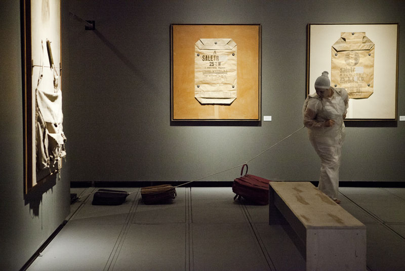 Tadeusz Kantor Machine, exhibition view, Sesc Consolação. Left to right: fragment of The Infanta, after Velasquez, 1966-70, works from the Industrial Bags series, 1964. Foreground: a performer from the Cia Antropofágica group. Photograph: Jeff Dias.